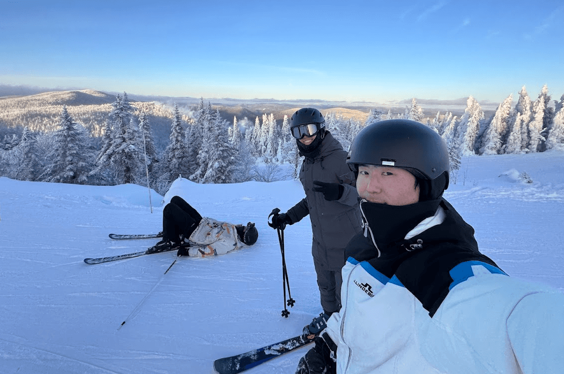 Peter Zhang skiing with friends in a snowy mountain landscape
